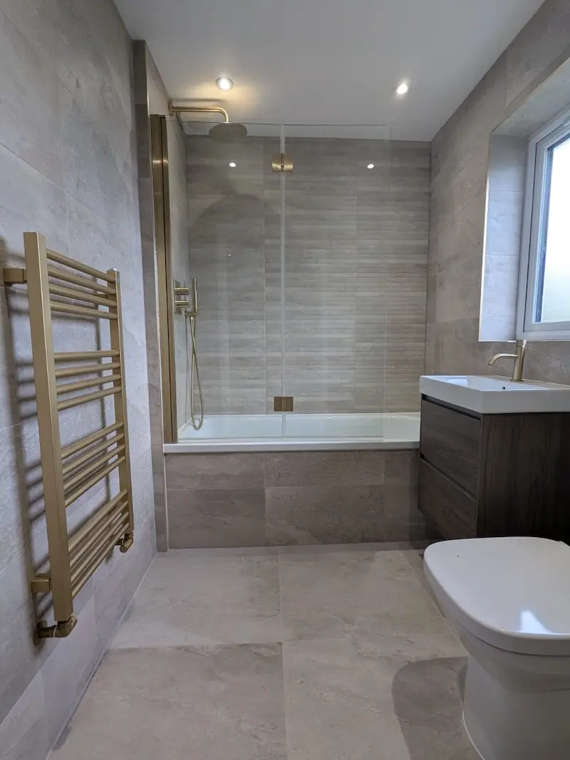 Downstairs toilet renovation, featuring tile floor, part tiled wall, integrated toilet and sink